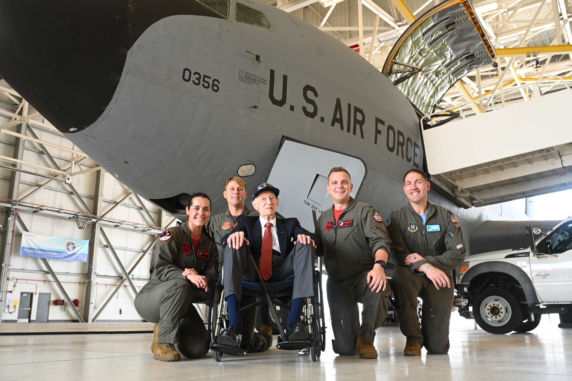 Boom operators and pilots from the 22nd Air Refueling Wing pose for a photo with retired Maj. John “Lucky” Luckadoo Sept. 6, 2024, at McConnell Air Force Base, Kansas. Luckadoo was stationed at McConnell during World War II in the 350th Bomb Squadron. The visit reminded future generations of the sacrifices made by his generation. (U.S. Air Force photo by Senior Airman William Lunn)