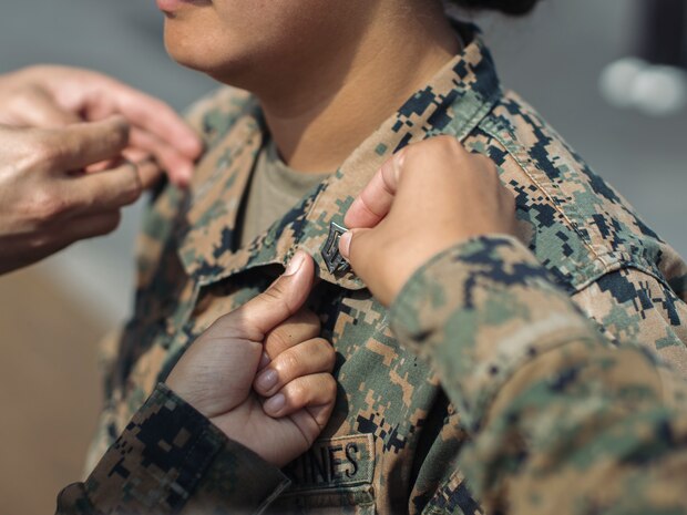 U.S. Marine Corps Sgt. Amelia Kang, a combat graphics specialist assigned to the 15th Marine Expeditionary Unit, and a native of Portland, Oregon, is promoted to sergeant aboard the amphibious assault ship USS Boxer (LHD 4) at Busan Naval Base, South Korea, Sept. 8, 2024. The 15th MEU was in South Korea conducting Exercise Ssang Yong 24 to strengthen the Republic of Korea-U.S. Alliance through bilateral, joint training, contributing toward combined amphibious capability in defense of the Korean Peninsula. (U.S. Marine Corps photo by Cpl. Joseph Helms)