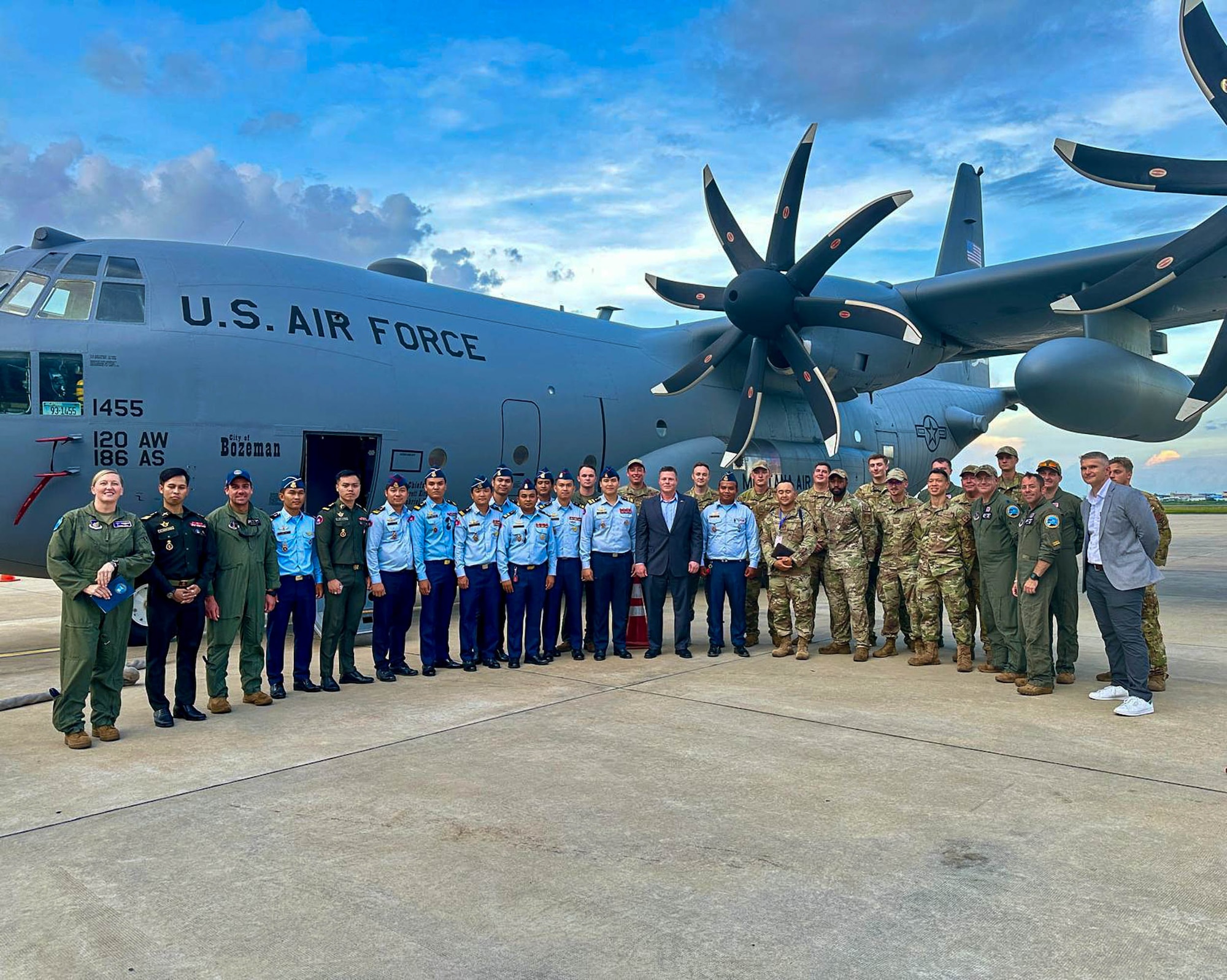 Montana Air National Guard members and the Royal Cambodian Air Force officers pose in front of C-130 J Hercules at the Phnom Penh International Airport in Phnom Penh, Cambodia.