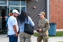 U.S. Airman 1st Class Isabella D’Alessandro, an aerospace medical service Airman assigned to the Ohio National Guard’s 180th Fighter Wing, helps a family through the registration process before they enter the Greene County Career Center for Guard Care in Xenia, Ohio, Aug. 11, 2024. Guard members helped provide free health care as part of the Department of Defense Innovative Readiness Training program.