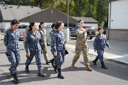 Washington Army National Guard Chief Warrant Officer 2 Kristin Retherford, 10th Civil Support Team survey team leader, gives Royal Thai Air Force officers a tour of the 10th CST facilities during a State Partnership Program engagement Sept. 11, 2024, at Camp Murray, Wash. The tour was part of the first female leadership-focused exchange with RTAF since Washington’s formal relationship with the Kingdom of Thailand began in 2002.