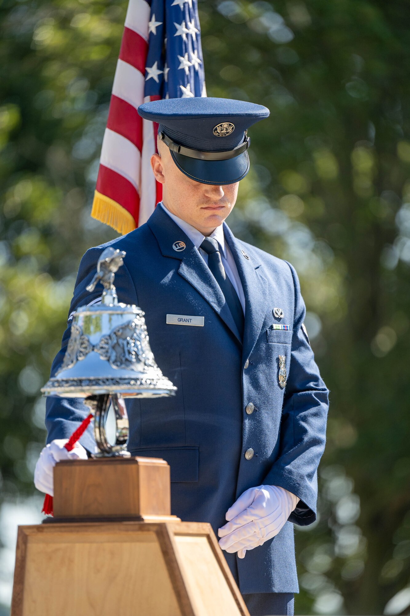 U.S. Air Force Airman 1st Class Jaren Grant, 436th Civil Engineer Squadron firefighter, performs the ringing of the bell ceremony at the 23rd Anniversary 9/11 Memorial Service at the Air Mobility Command Museum on Dover Air Force Base, Delaware, Sept. 11, 2024. Members of Team Dover along with local firefighter communities paid respect to the victims of 9/11 and participated in the memorial. (U.S. Air Force photo by Mauricio Campino)