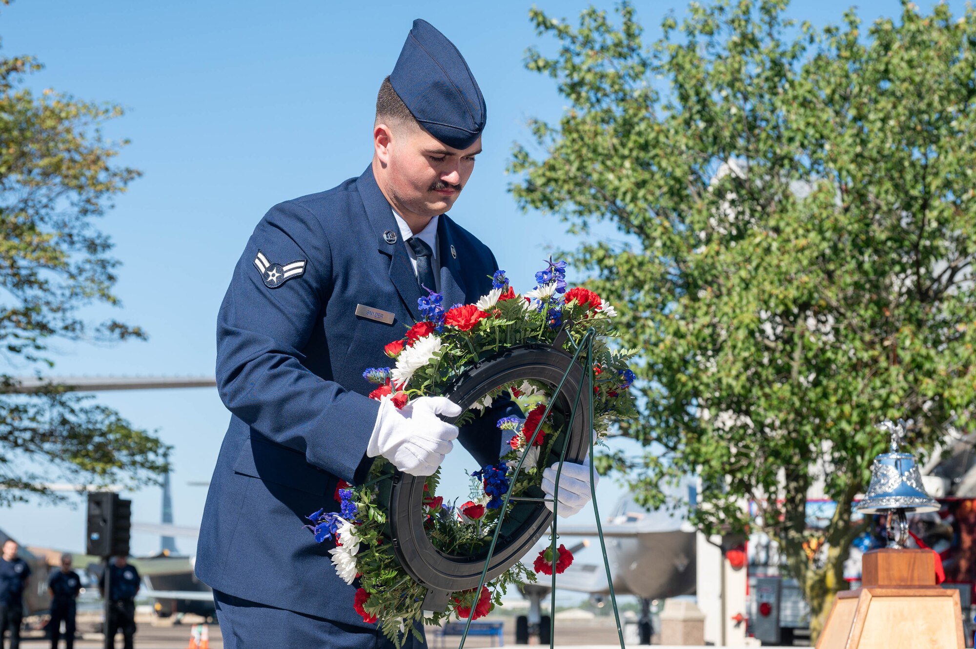 Airman 1st Class Ryan Snyder, 436th Civil Engineer Squadron firefighter, lays a wreath at a 9/11 memorial during the 23rd Anniversary 9/11 Memorial Service at the Air Mobility Command Museum on Dover Air Force Base, Delaware, Sept. 11, 2024. The 9/11 Memorial at the museum includes two pieces of steel from the World Trade Center, a rock from the United Airlines Flight 93 crash site and a block from the American Airlines Flight 77 crash site at the Pentagon. (U.S. Air Force photo by Mauricio Campino)