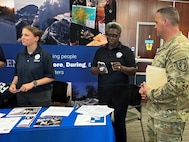 CW2 Michael Yoha speaks with FEMA representatives at a job fair