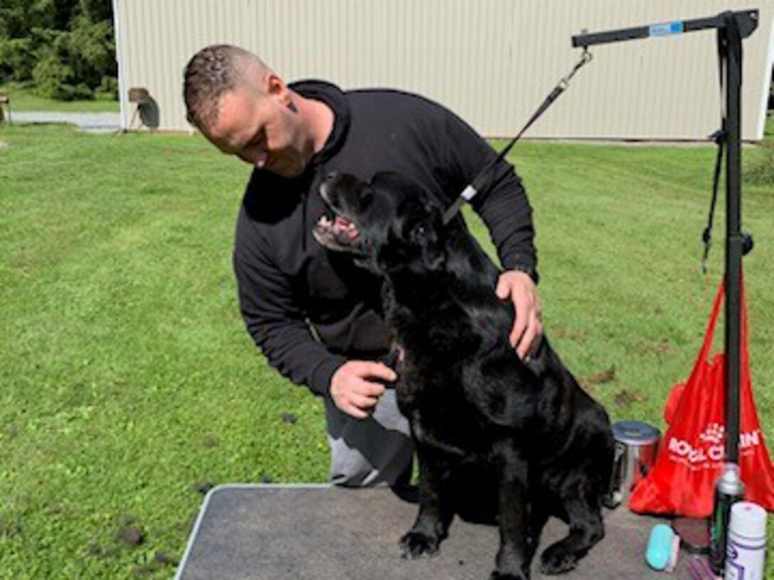 CW2 Michael Yoha works with  “Zucco” during an occupational therapy event
