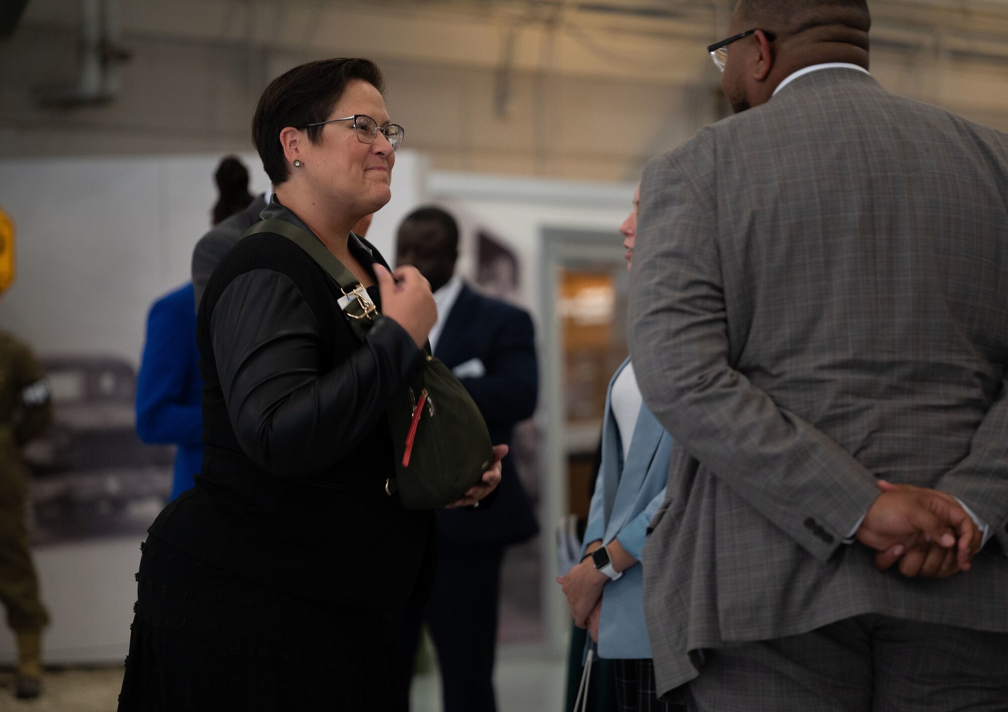Jaimie Watts, Leadership Delaware Inc. chief of operations, mingles with other members of LDI after a mission brief at the Air Mobility Command Museum at Dover Air Force Base, Delaware, Sept. 6, 2024. U.S. Air Force Col. Brian Ellis, 436th Mission Support Group commander, briefed LDI members on the Dover AFB mission, shared his knowledge and answered questions from members. LDI is a nonprofit that recruits young leaders from Delaware to develop them into leaders that can foster positive change in their community. (U.S. Air Force photo by Airman Liberty Matthews)