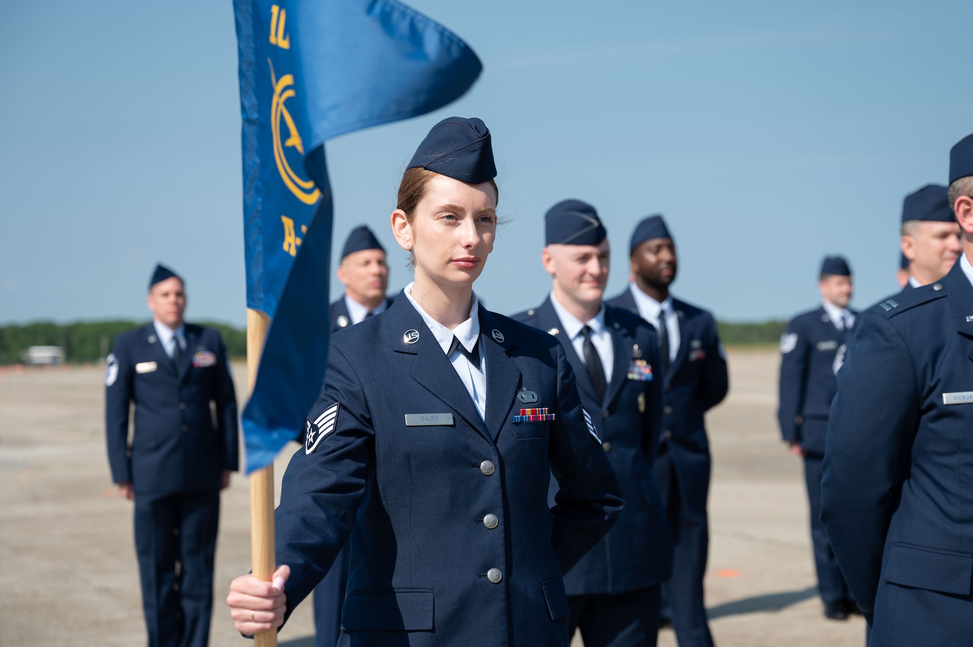 Airmen stand at attention.