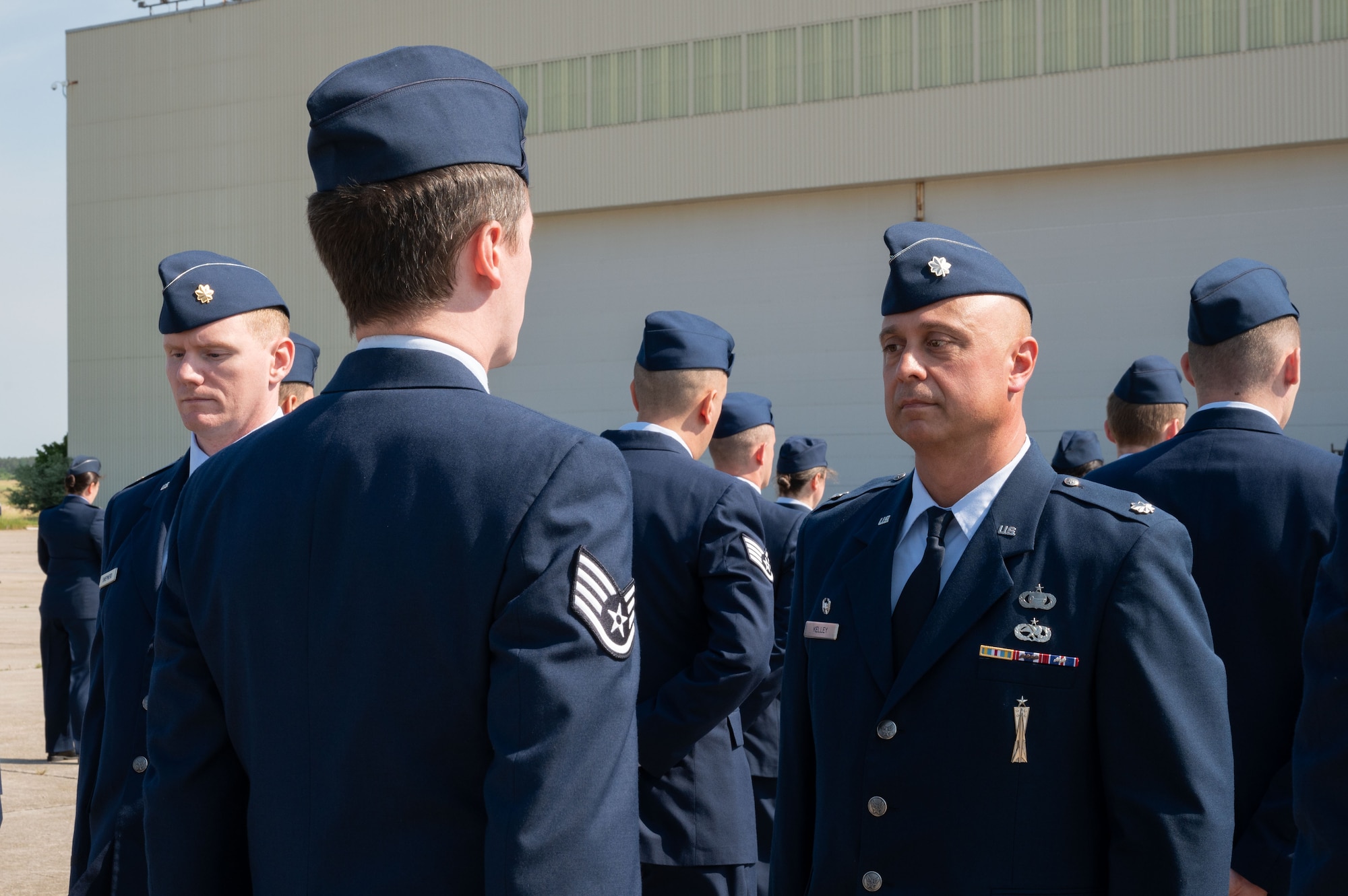 Airmen stand at attention.