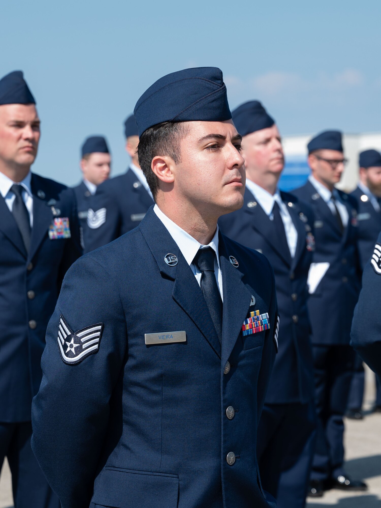 Airmen stand at attention.