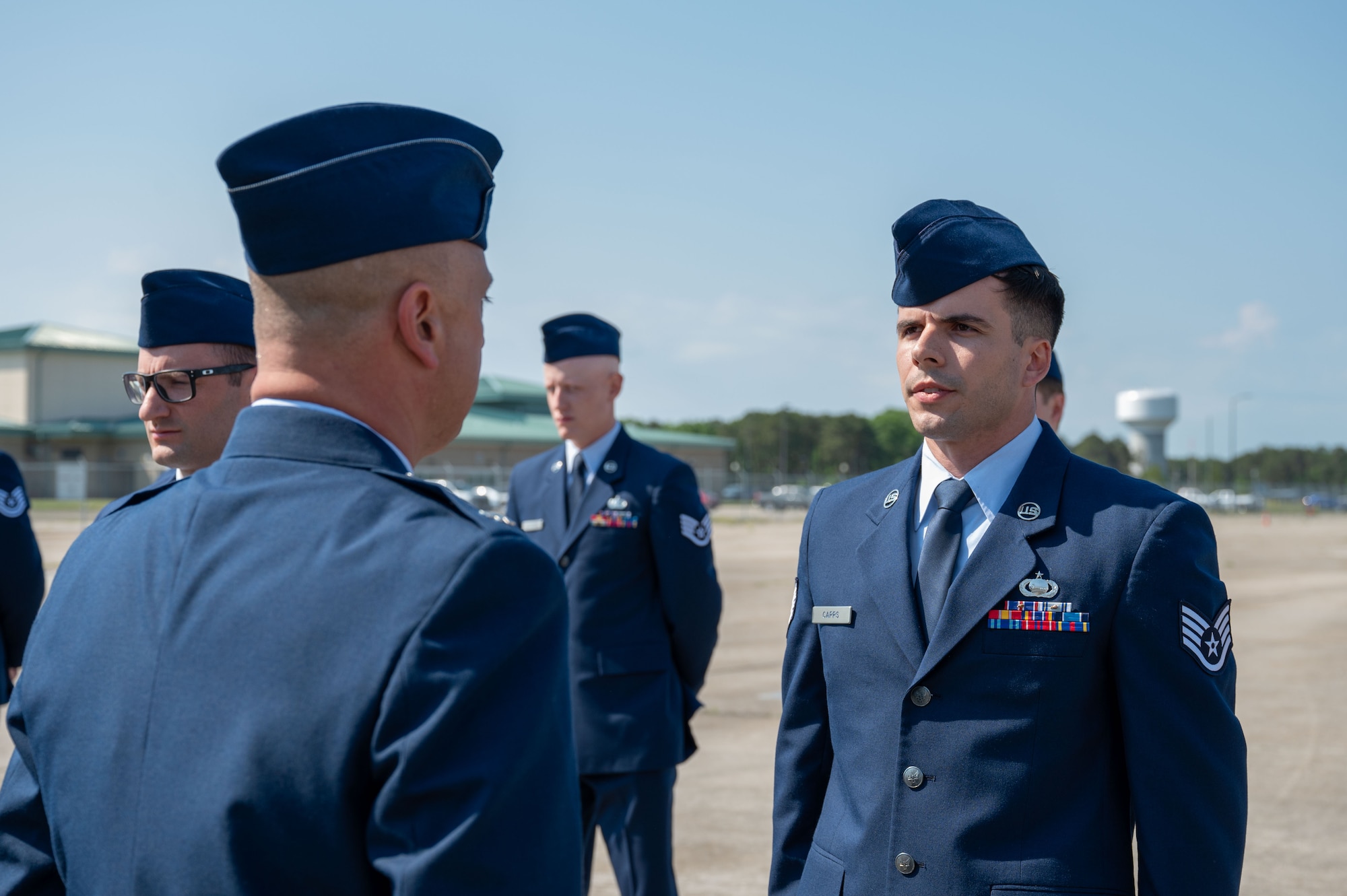 Airmen stand at attention.