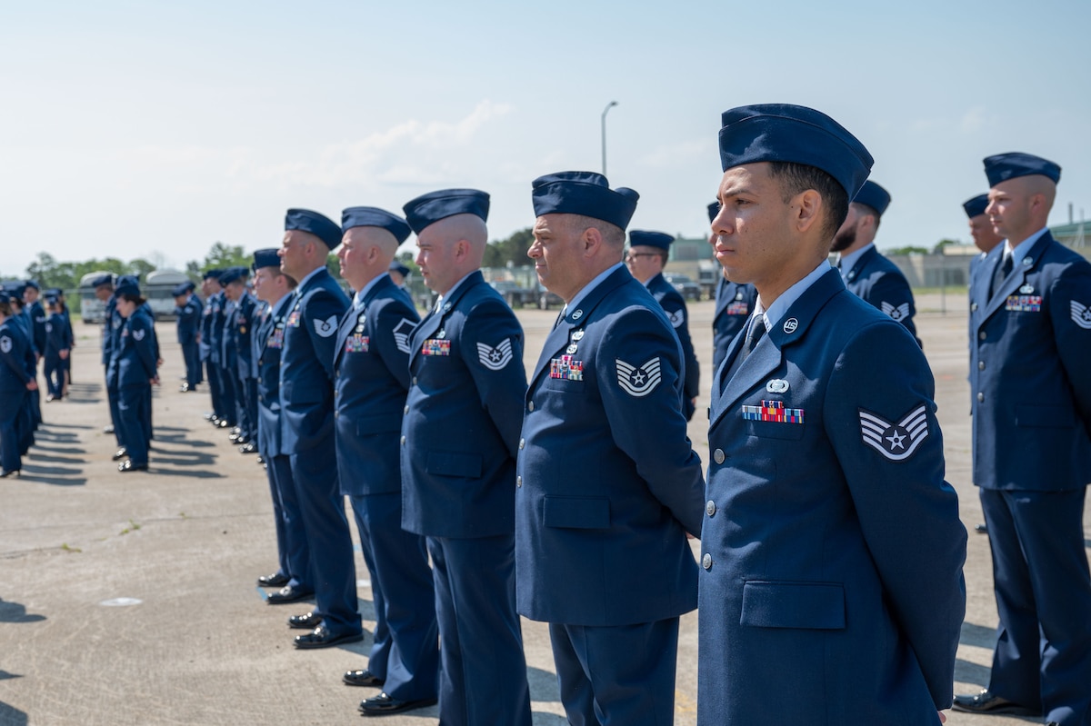 Airmen stand at attention.