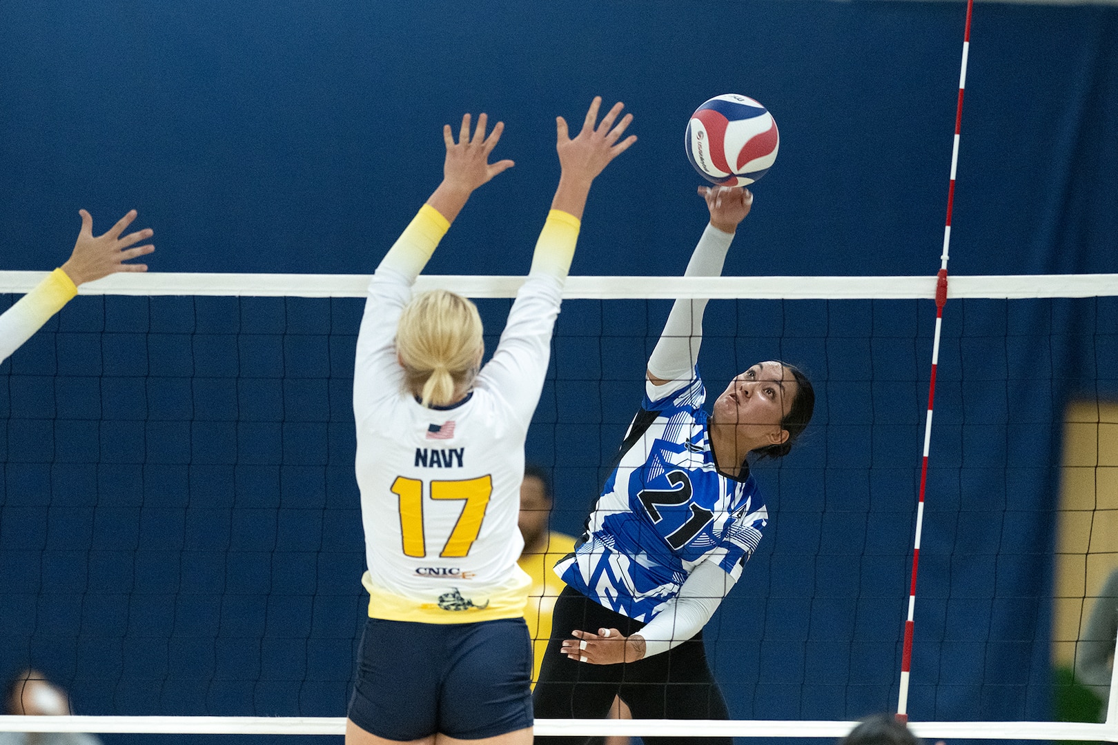 Air Force outside hitter Senior Airman Alexus Paglinawan of Moody AFB, Georgia hits past Navy defender during the 2024 Armed Forces Men’s and Women’s Volleyball Championships at Fort Carson, Colo. Sept. 11, 2024. (DoD photo by EJ Hersom)