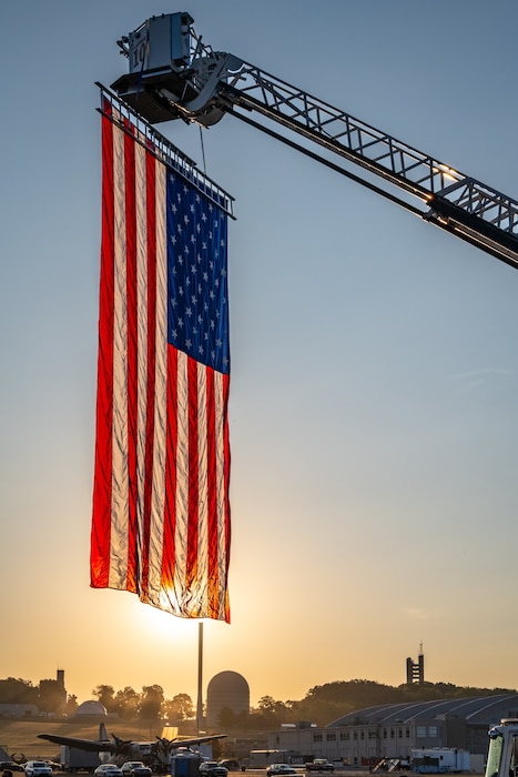 A U.S. flag is illuminated by the golden morning light