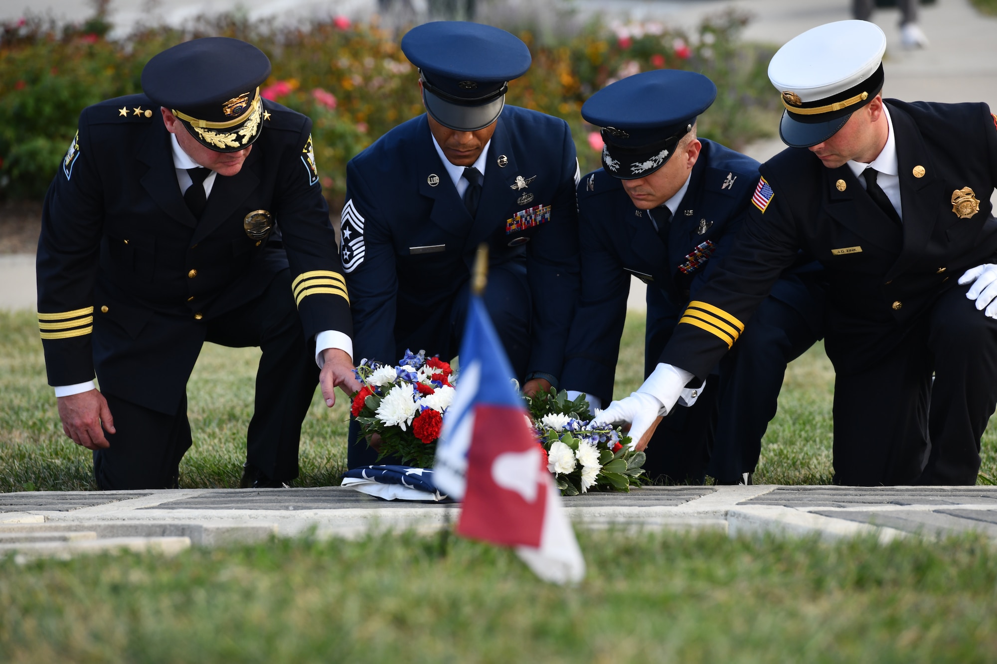 Chief Ken Clary of the Bellevue Police Department, Chief Master Sgt. Andrew Small, 55th Wing command chief, Col. Aaron Gray, 55th Wing deputy commander, and Battalion Commander Jeremy Zink of the Bellevue Fire Department, lay a memorial wreath at the 9/11 memorial service at American Heroes Park in Bellevue, Neb. on Sept. 11, 2024.(U.S. Air Force photo by Chad Watkins)