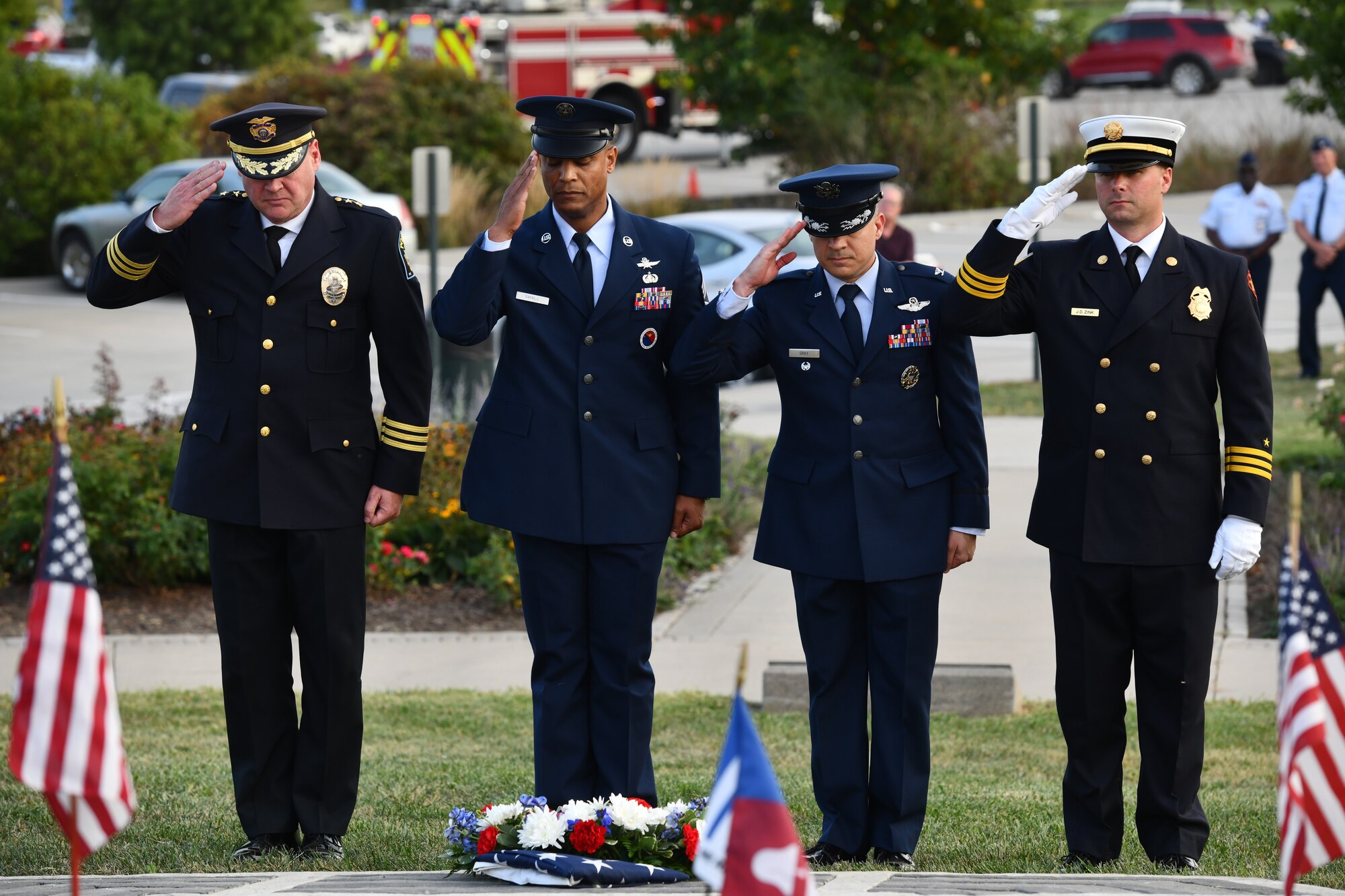 Chief Ken Clary of the Bellevue Police Department, Chief Master Sgt. Andrew Small, 55th Wing command chief, Col. Aaron Gray, 55th Wing deputy commander, and Battalion Commander Jeremy Zink of the Bellevue Fire Department, render a salute after laying a memorial wreath at the 9/11 memorial service at American Heroes Park in Bellevue, Neb. on Sept. 11, 2024.(U.S. Air Force photo by Chad Watkins)