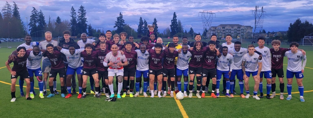 Soccer team members pose for a group photo.
