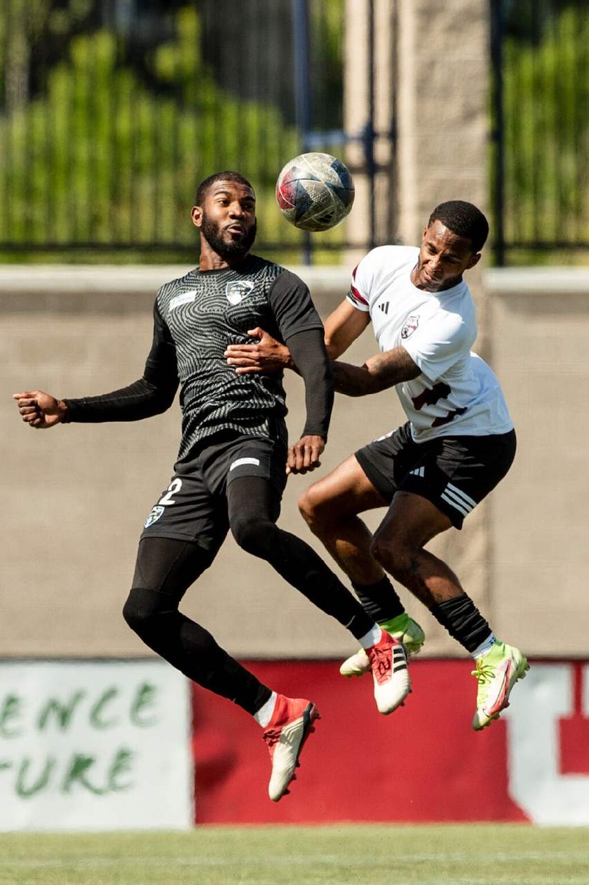Soccer players scramble for the ball.