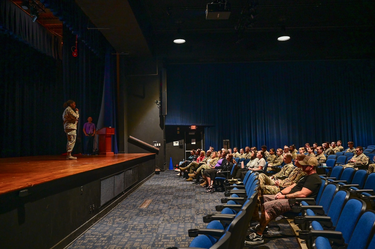A crowd listens to a speaker.