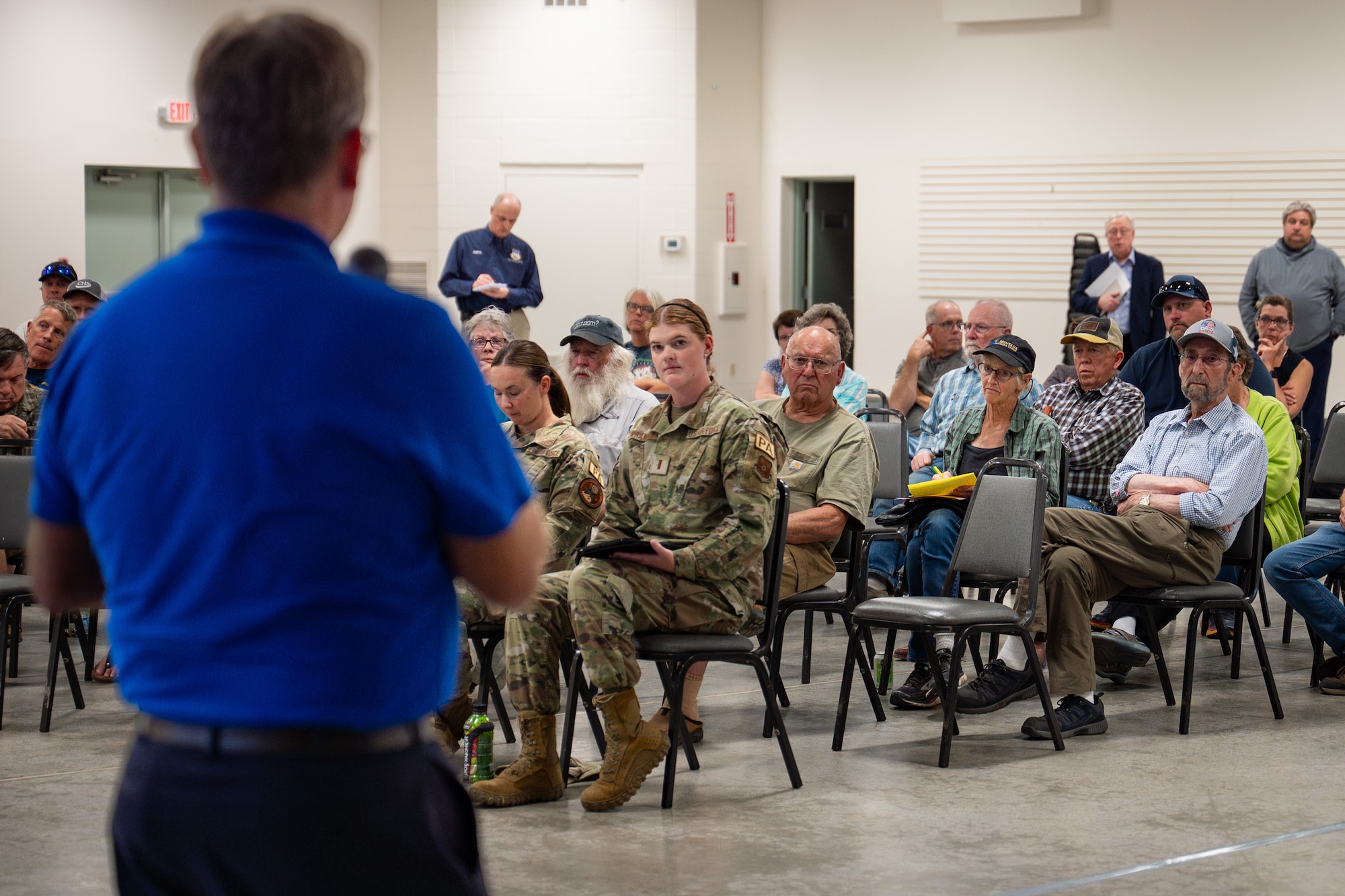Uniformed personnel interact with members of the community.