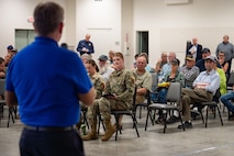Uniformed personnel interact with members of the community.