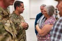 Uniformed personnel interact with members of the community.