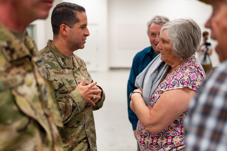 Uniformed personnel interact with members of the community.