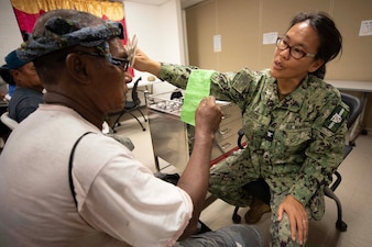 Capt. Sharlene Gee examines a patient for glasses at Yap State Hospital.