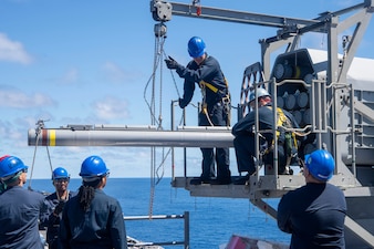 Sailors transport ordnance aboard USS America (LHA 6) in the Philippine Sea.