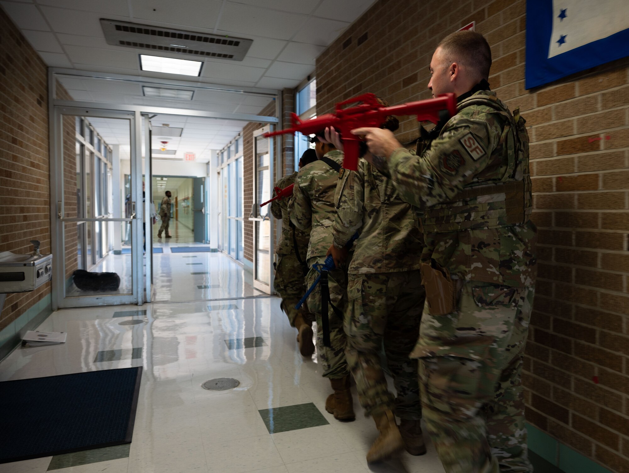 Airmen from the 436th Security Forces Squadron learn how to move while using the stacking technique during school shooter response training at Dover, Delaware, Sept. 10, 2024. The training was used to aid the 436th SFS in reaffirming readiness in response to an active school shooter. (U.S. Air Force Photo by Senior Airman Dieondiere Jefferies)