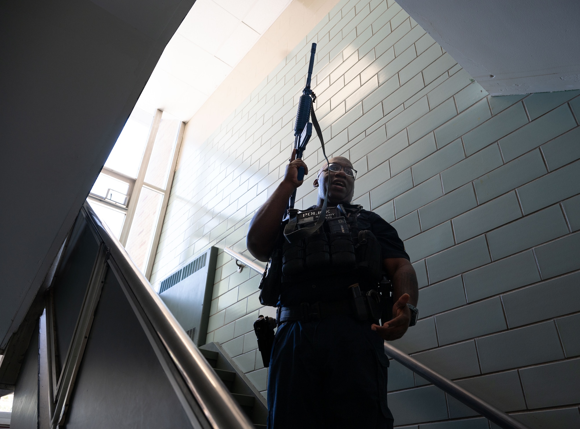 Officer Conrad Savoury, 436th Security Forces Squadron flight sergeant, teaches 436th SFS members how to check for danger in a staircase during school shooter response training at Dover, Delaware, Sept. 10, 2024. The training was used to aid the 436th SFS in reaffirming readiness in response to an active school shooter. (U.S. Air Force Photo by Senior Airman Dieondiere Jefferies)