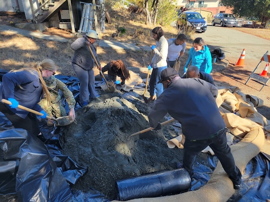 Participants fill sandbags during a flood fighting training Nov. 2, 2022, in Marin City, Calif.