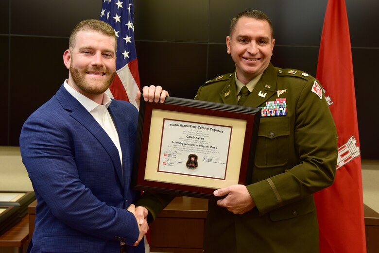Caleb Ayres, U.S. Army Corps of Engineers Nashville District, receives a certificate of completion for the 2024 Leadership Development Program Level II Course from Lt. Col. Robert W. Green, Nashville District commander, during a graduation ceremony Sept. 11, 2024, at the district headquarters in Nashville, Tennessee. (USACE Photo by Lee Roberts)