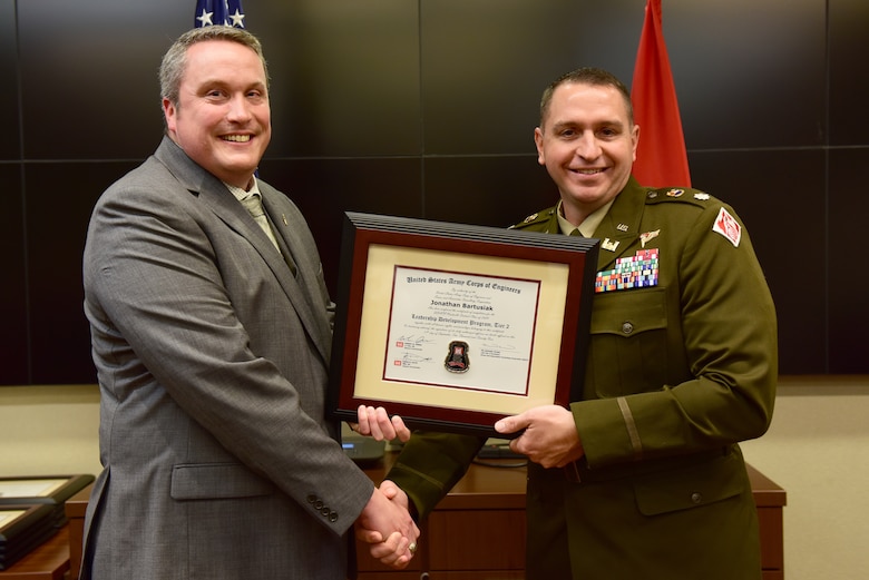 Jonathan Bartusiak, U.S. Army Corps of Engineers Nashville District, receives a certificate of completion for the 2024 Leadership Development Program Level II Course from Lt. Col. Robert W. Green, Nashville District commander, during a graduation ceremony Sept. 11, 2024, at the district headquarters in Nashville, Tennessee. (USACE Photo by Lee Roberts)