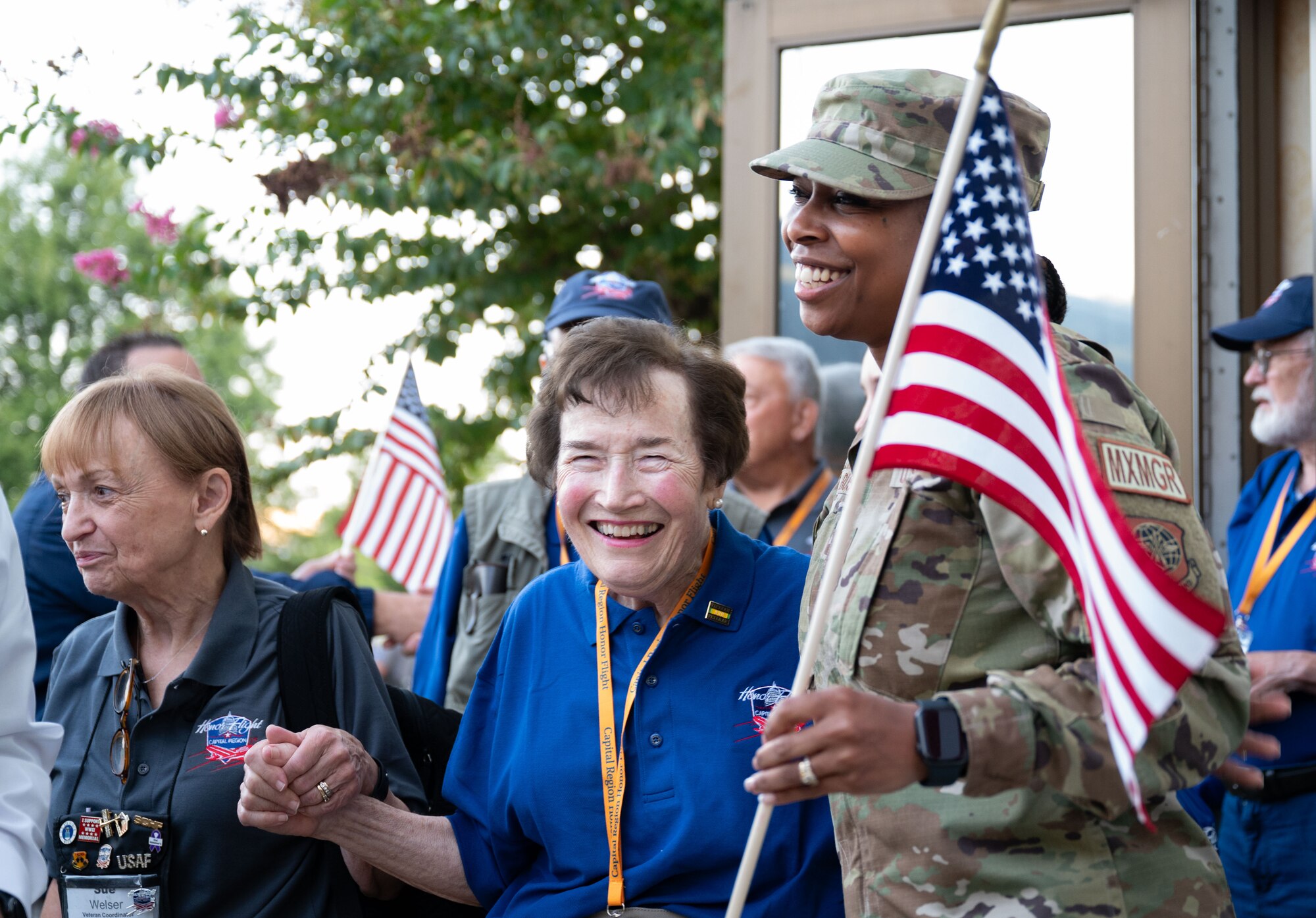 U.S. Air Force Chief Master Sgt. Carolyn Russell, right, 436th Airlift Wing command chief, and U.S. Air Force veteran Penny Schneider, center, embrace before Penny boards the bus for the Capital Region Honor Flight, at Bally’s Dover Casino Resort, Dover, Delaware, Sept. 12, 2024. The Honor Flight is a program for U.S. veterans to visit monuments in Washington D.C. for a day, honoring them and giving proper recognition to their service. (U.S. Air Force photo by Airman Liberty Matthews)
