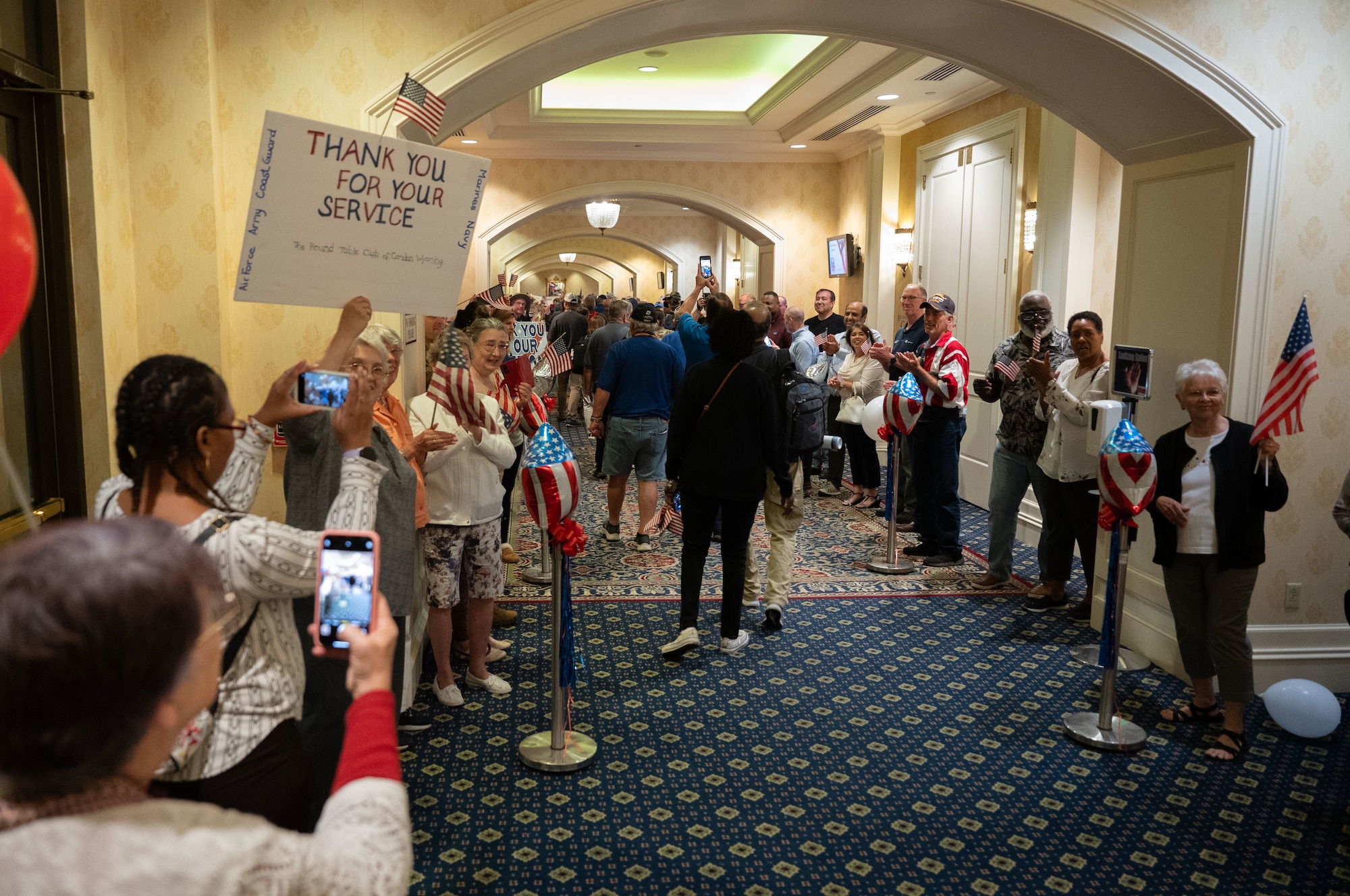 Veterans walk down the welcome home line, greeted by friends and family upon returning with the Capital Region Honor Flight, at Bally’s Dover Casino Resort, Dover, Delaware, Sept. 12, 2024. The Honor Flight is a program for U.S. veterans to visit monuments in Washington D.C. for a day, honoring them and giving proper recognition to their service. (U.S. Air Force photo by Airman Liberty Matthews)