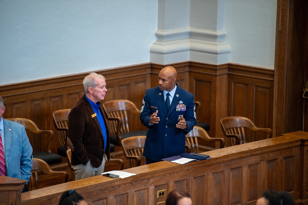 U.S. Air Force Chief Master Sgt. Dion Bullock, 23rd Civil Engineer Squadron fire chief, speaks to Mayor Scott James Matheson, Valdosta mayor, at Lowndes County Courthouse, Valdosta, Georgia, Sept. 11, 2024. Community leaders attended the memorial in order to pay their respects. (U.S. Air Force photo by Airman 1st Class Iain Stanley)