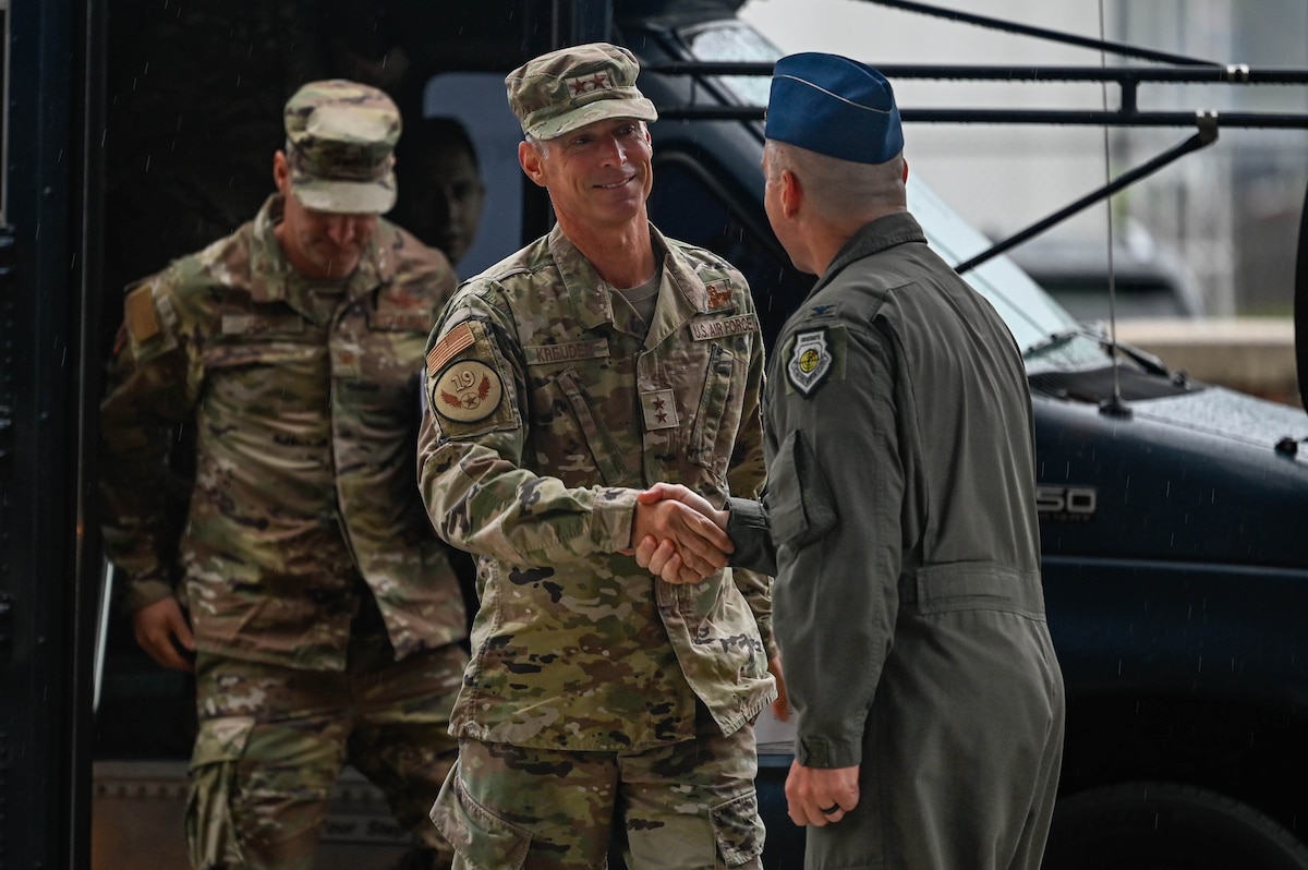Airmen shake hands.