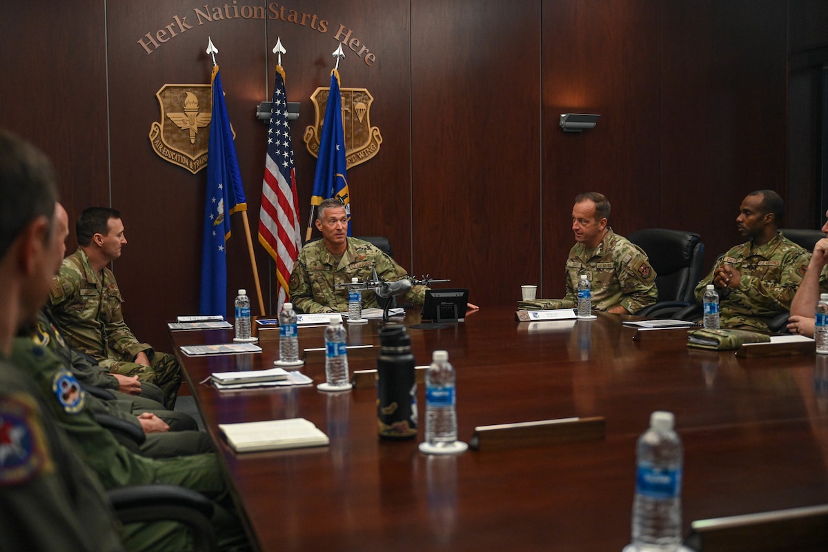 People sit around a conference room table.