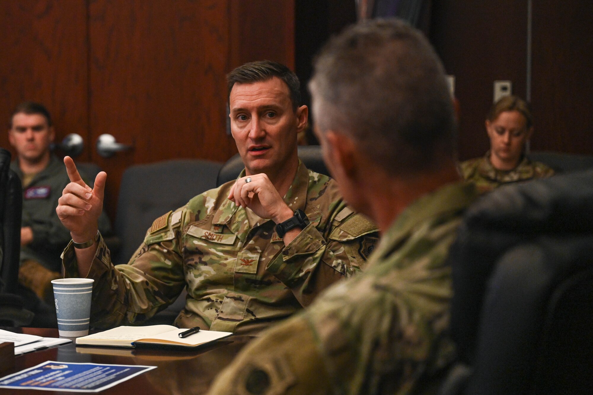 People sit around a conference room table.