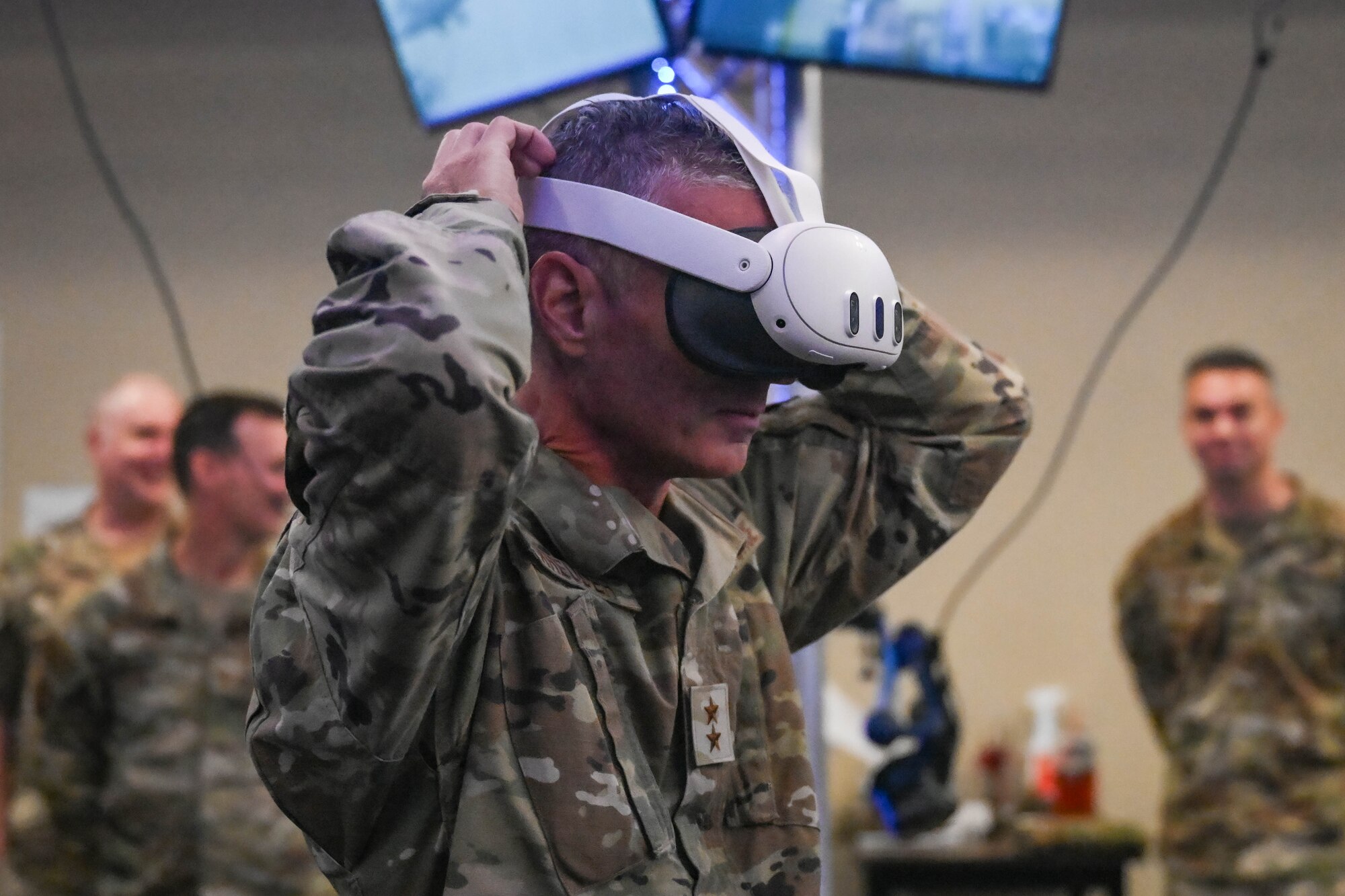 Maj. Gen. Gregory Kreuder dons a virtual reality headset.
