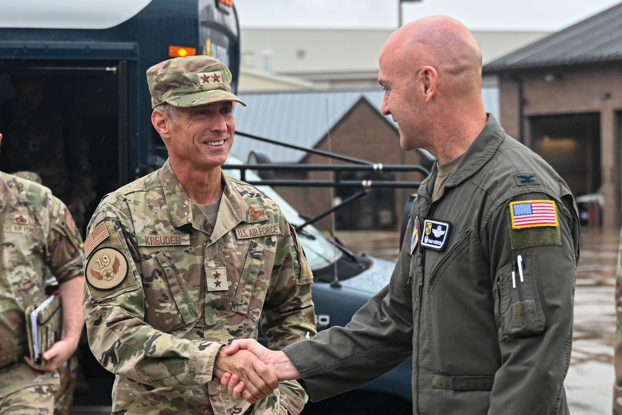 Airmen shake hands.