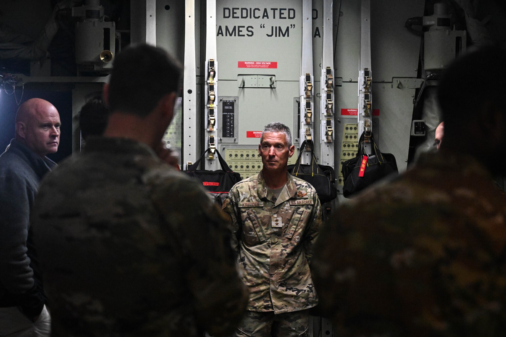 Maj. Gen. Gregory Kreuder stands in front of a group.