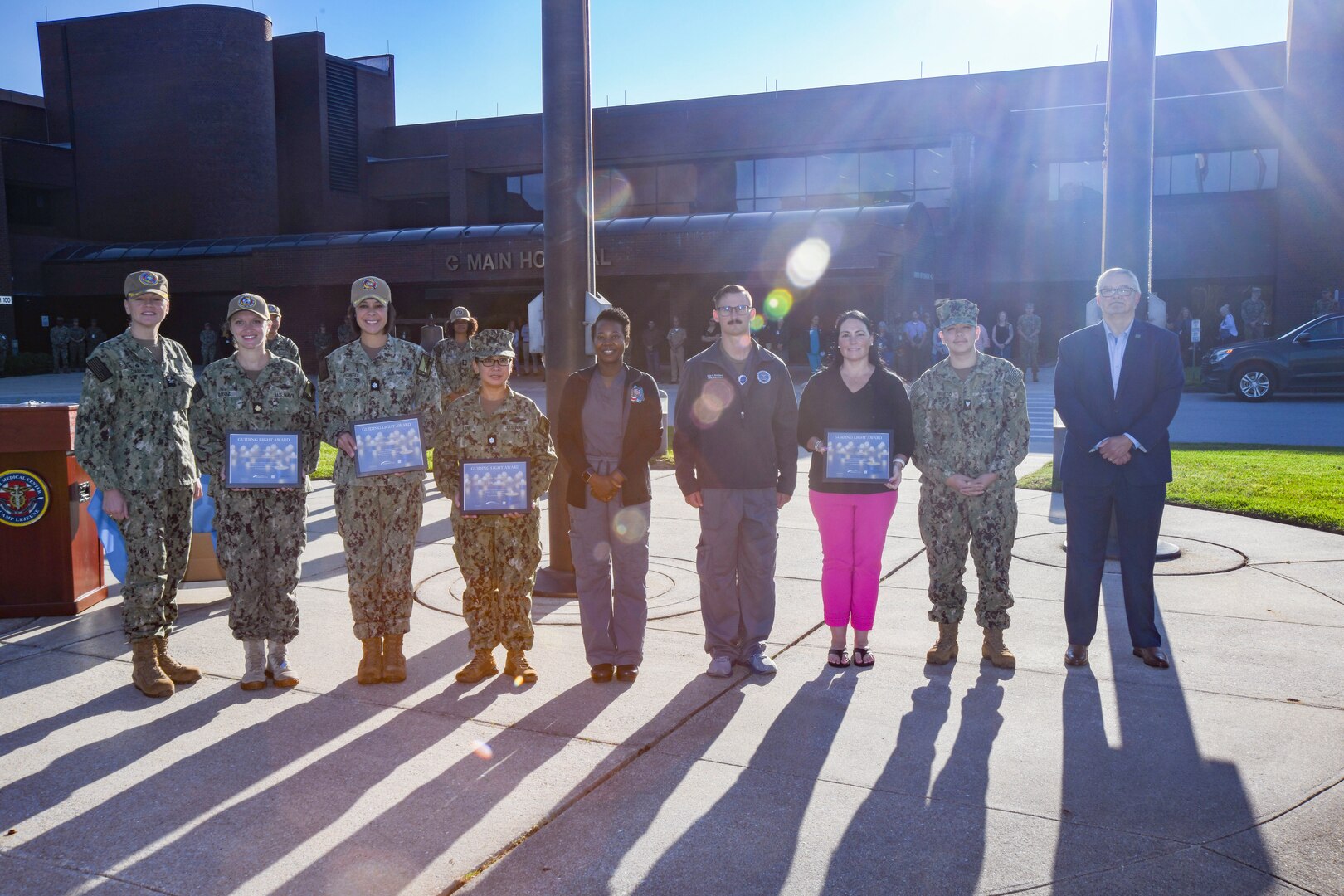 Naval Medical Center Camp Lejeune Director/Commander Capt. Anja Dabelić (far left) and Mr. Charles White, HonorBridge representative (far right), join Naval Medical Center Camp Lejeune employees with the Transfer Center, Intensive Care Unit, and nursing teams to receive the “Guiding Light Award” on Aug. 22, 2024. The award is given by HonorBridge, the largest organ procurement organization in the states of North Carolina and Virginia, to facilities that provide dedicated, compassionate care to organ donors. NMCCL cared for a Marine earlier this year whose final act was the selfless gift of organ donation.