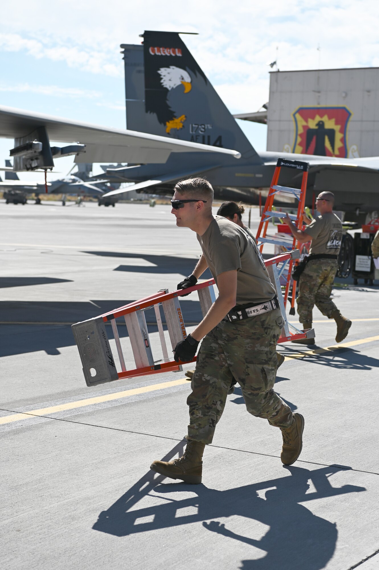 U.S. Air Force Staff Sgt. Quinten Green 173rd Aircraft Maintenance Squadron runs with a ladder.