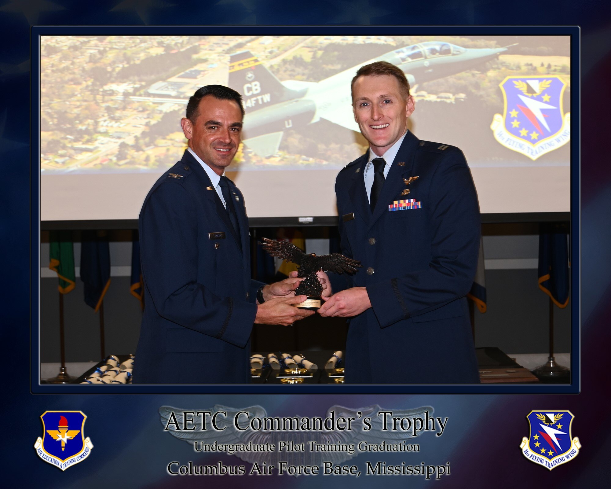 Col. Stuart Rubio presents the AETC Commander's Trophy to Capt. Ryan Delahunt on September 13, 2024, at Columbus Air Force Base. The AETC Commander's Trophy is presented to the most outstanding graduate of the class from each track out training.