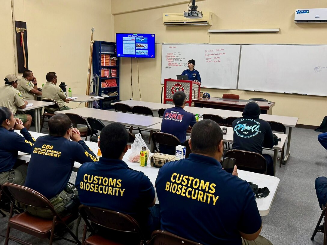 Lt. Chelsea Garcia, of the response department and a search and rescue mission coordinator, discusses search fundamentals as U.S. Coast Guard Forces Micronesia/Sector Guam and Station Apra Harbor personnel team up with local rescue units and enforcement officers from the Commonwealth of the Northern Mariana Islands for an intensive three-day Search and Rescue Exercise (SAREx) in Saipan from Sept. 10-12, 2024. The event began with visits to critical facilities, including the Emergency Operations Center at Homeland Security and Emergency Management, the Customs and Biosecurity Office, and the Division of Fish and Wildlife, where U.S. Coast Guard personnel conducted walkthroughs of search and rescue assets, discussed routine operations and procedures, and engaged in meet-and-greets with new leadership, including the Emergency Management and Communications Chiefs. (U.S. Coast Guard photo by Chief Petty Officer Richard Hofschneider)