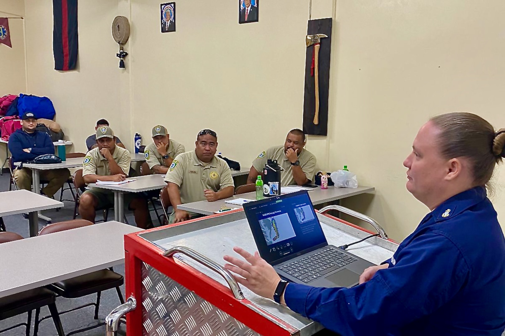 Chief Petty Officer Leslie Kirk discusses command center operations as U.S. Coast Guard Forces Micronesia/Sector Guam and Station Apra Harbor personnel team up with local rescue units and enforcement officers from the Commonwealth of the Northern Mariana Islands for an intensive three-day Search and Rescue Exercise (SAREx) in Saipan from Sept. 10-12, 2024. This year's exercise brought together a robust team of responders, including members from the CNMI Department of Emergency and Medical Services, CNMI Customs and Biosecurity, CNMI Homeland Security and Emergency Management, and the CNMI Division of Fish & Wildlife, all working towards enhancing search and rescue capabilities, communication protocols, and partnerships within the Northern Marianas. (U.S. Coast Guard photo by Chief Petty Officer Richard Hofschneider)