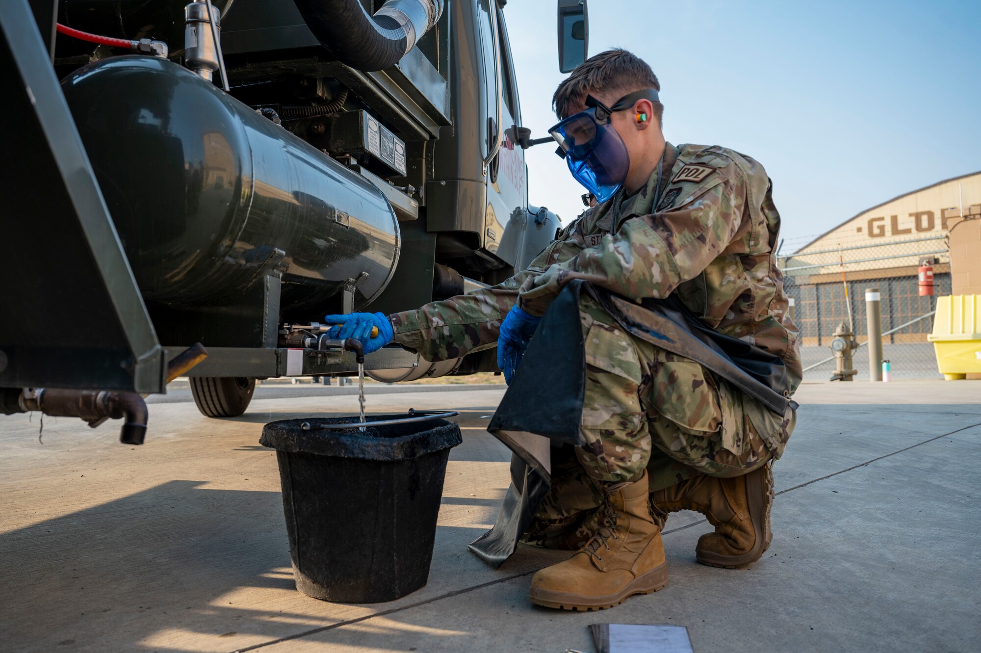 An Airman drains fuel from a truck.