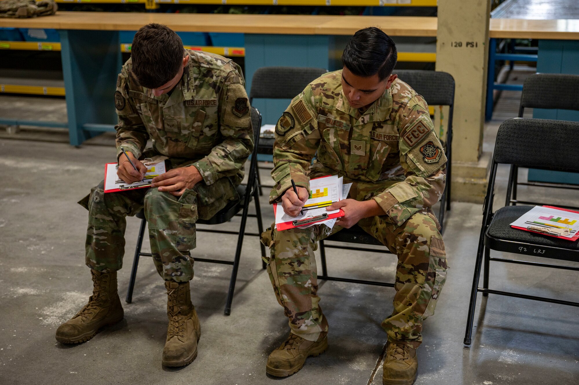 Airmen fill out forms.