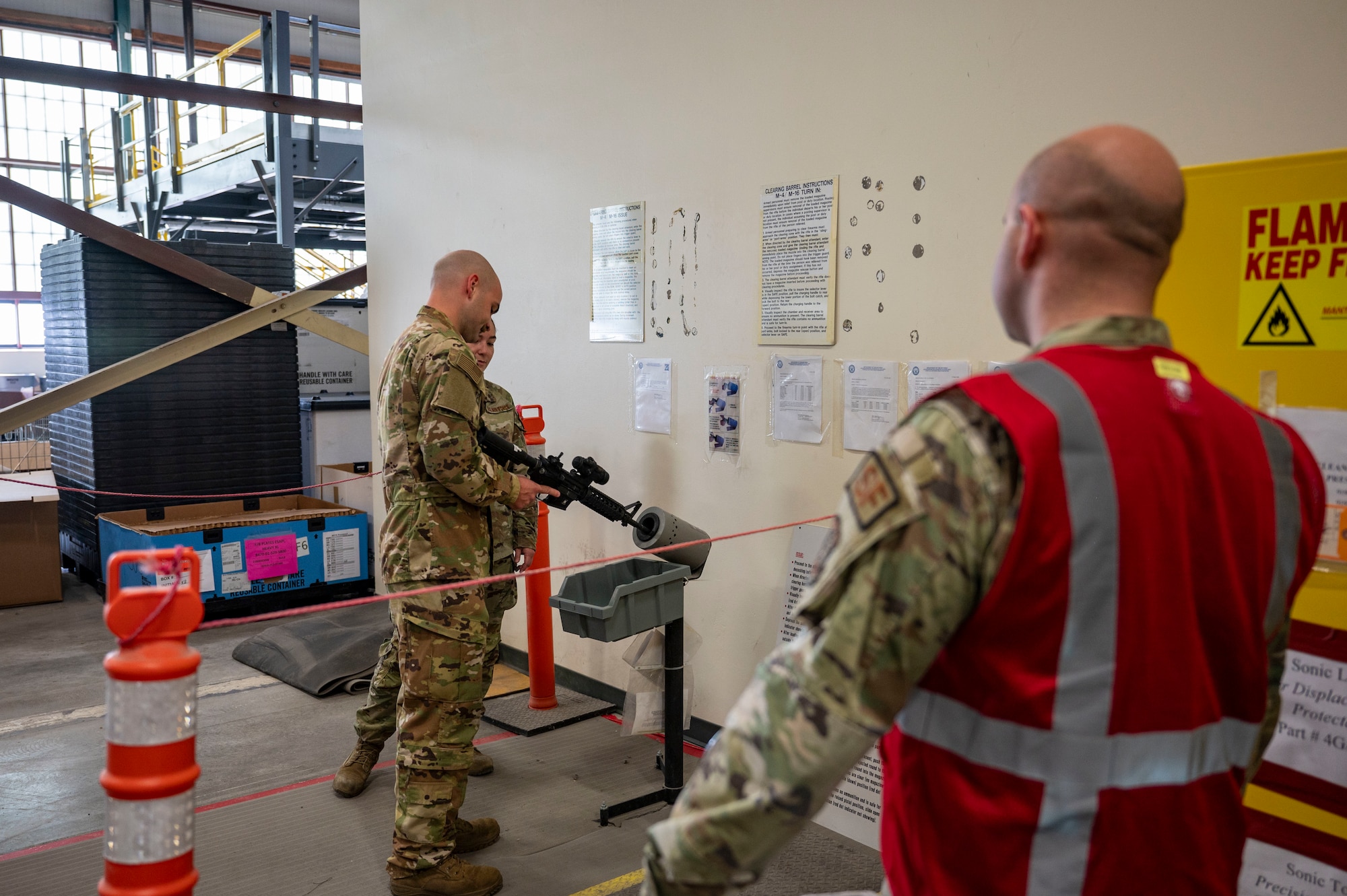 Airmen perform clearing barrel procedures.